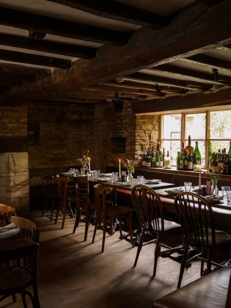 Beamed dining room laid for dinner at The Mason’s Arms, Clanfield